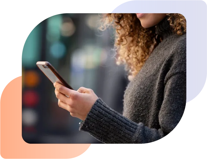 woman checking phone for cars for sale on google vehicle ads listing