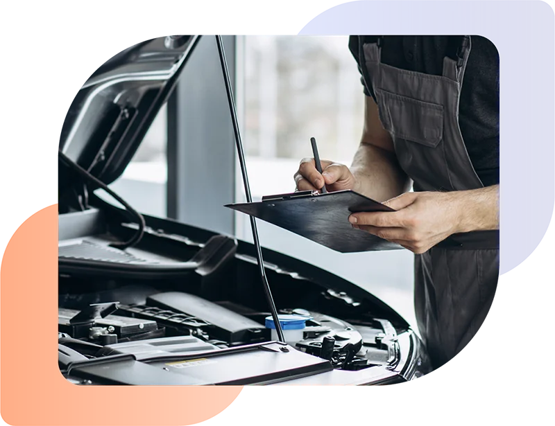 Man checking car engine as part of an automotive warranty repair