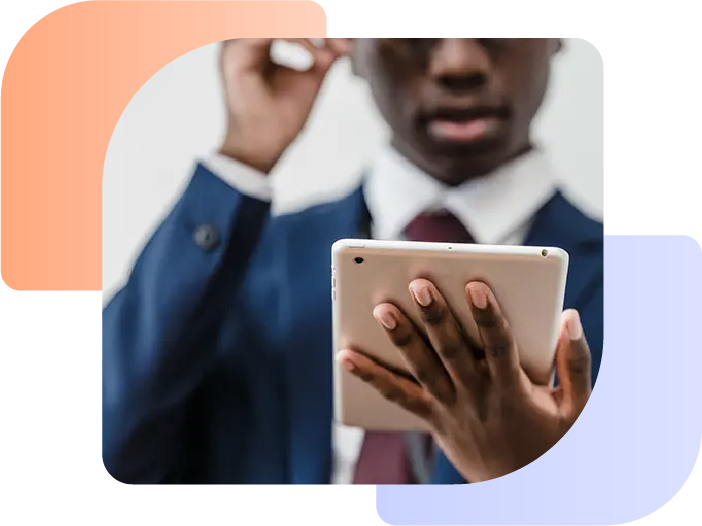 Man looking at a tablet displaying making tax digital for dealerships