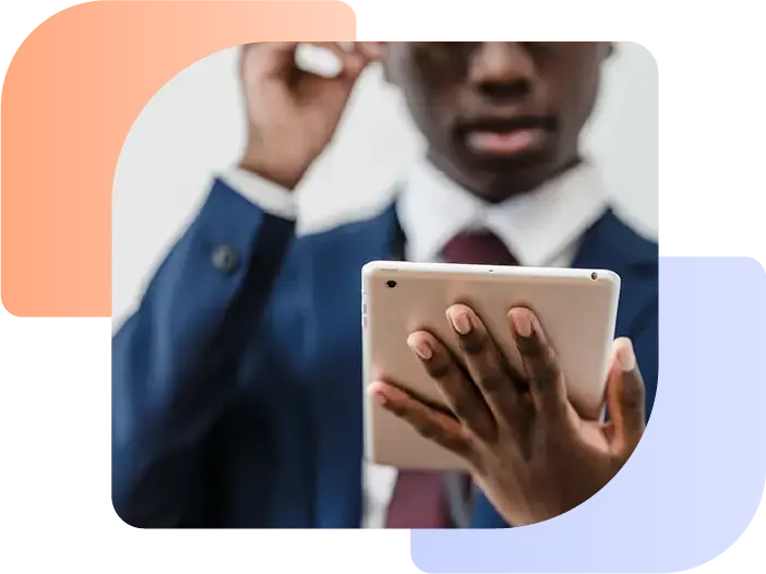 Man looking at a tablet displaying making tax digital for dealerships