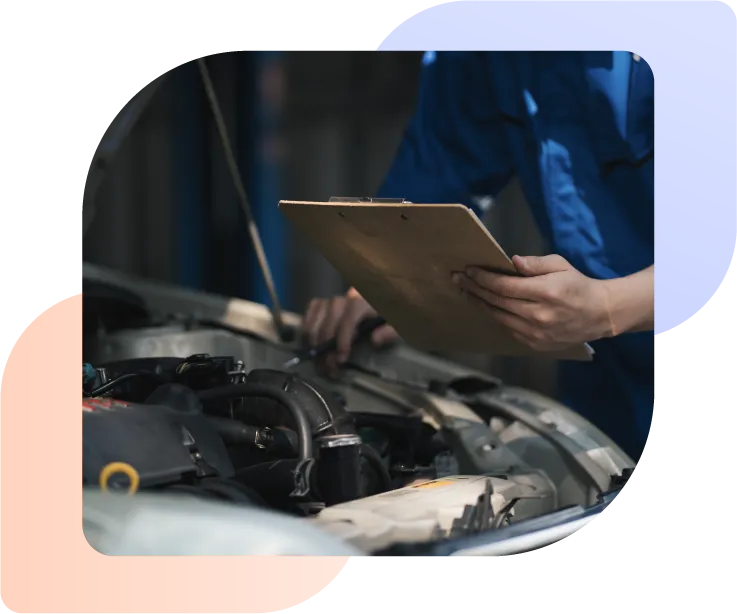 Man checking car engine as part of an automotive warranty repair