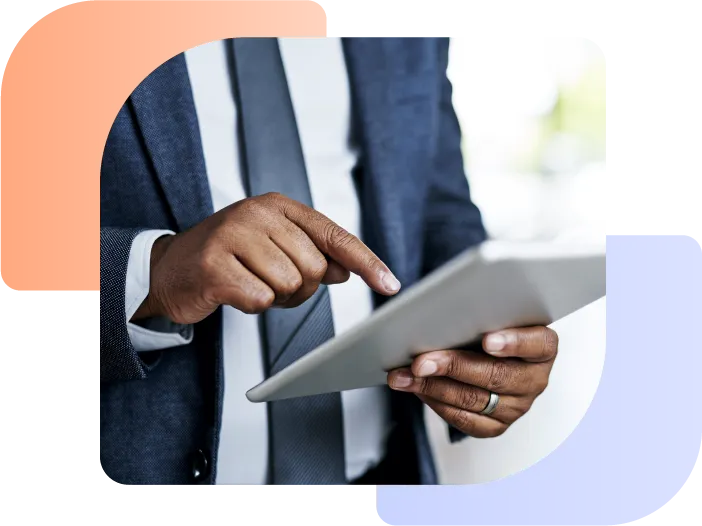 Man looking at a tablet displaying making tax digital for dealerships